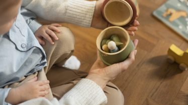 close-up-parent-kid-with-toy