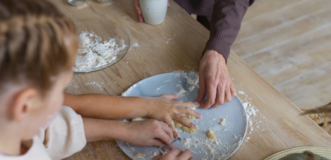 woman-helping-kids-cook-high-angle