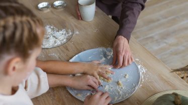woman-helping-kids-cook-high-angle